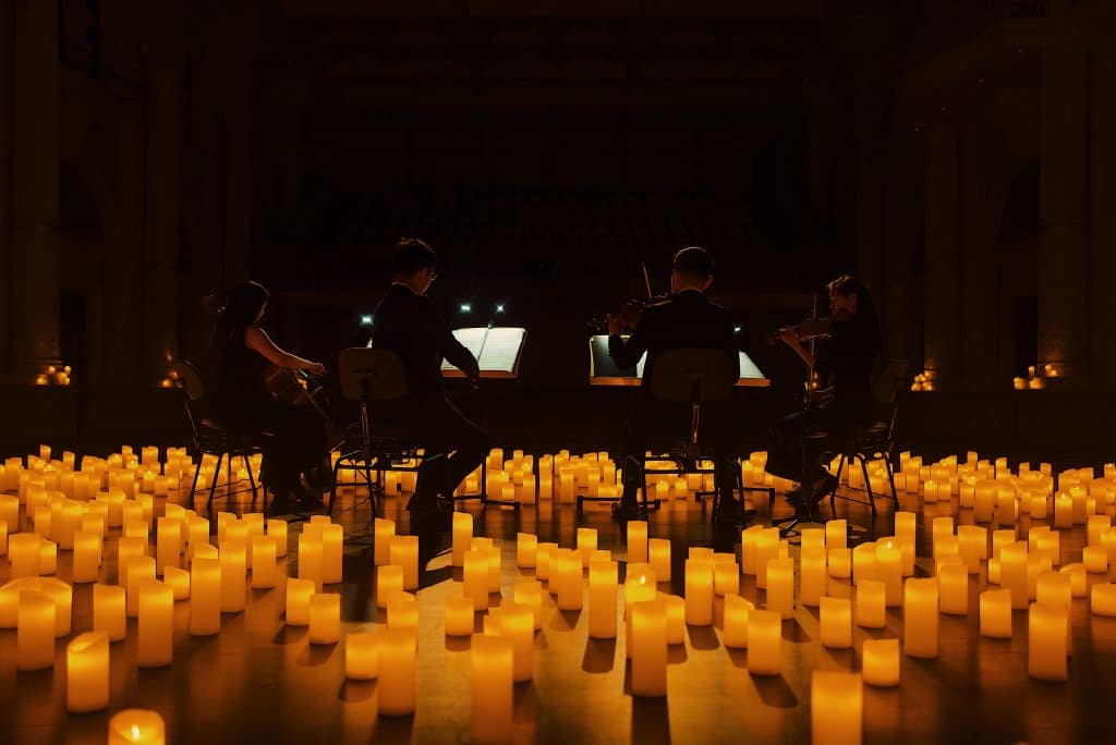 quartet surrounded by candles on stage