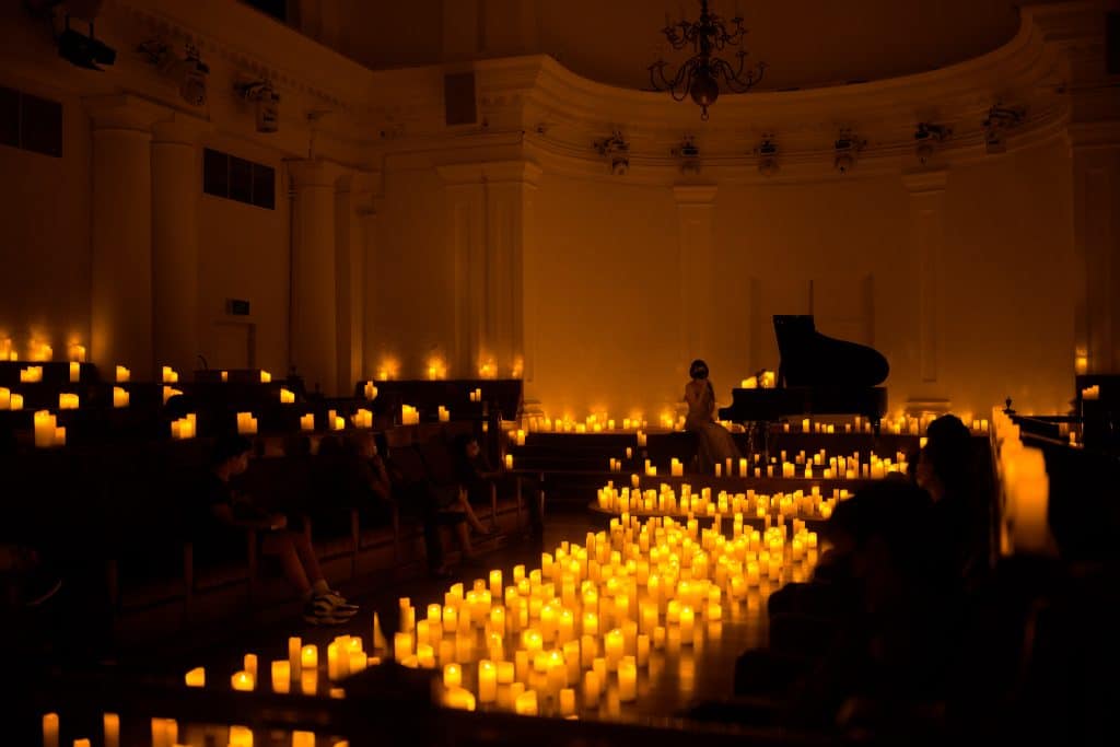 chamber at the arts house lit up with hundreds of candles