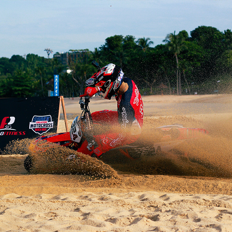 motocross rider taking a corner in beach race singapore