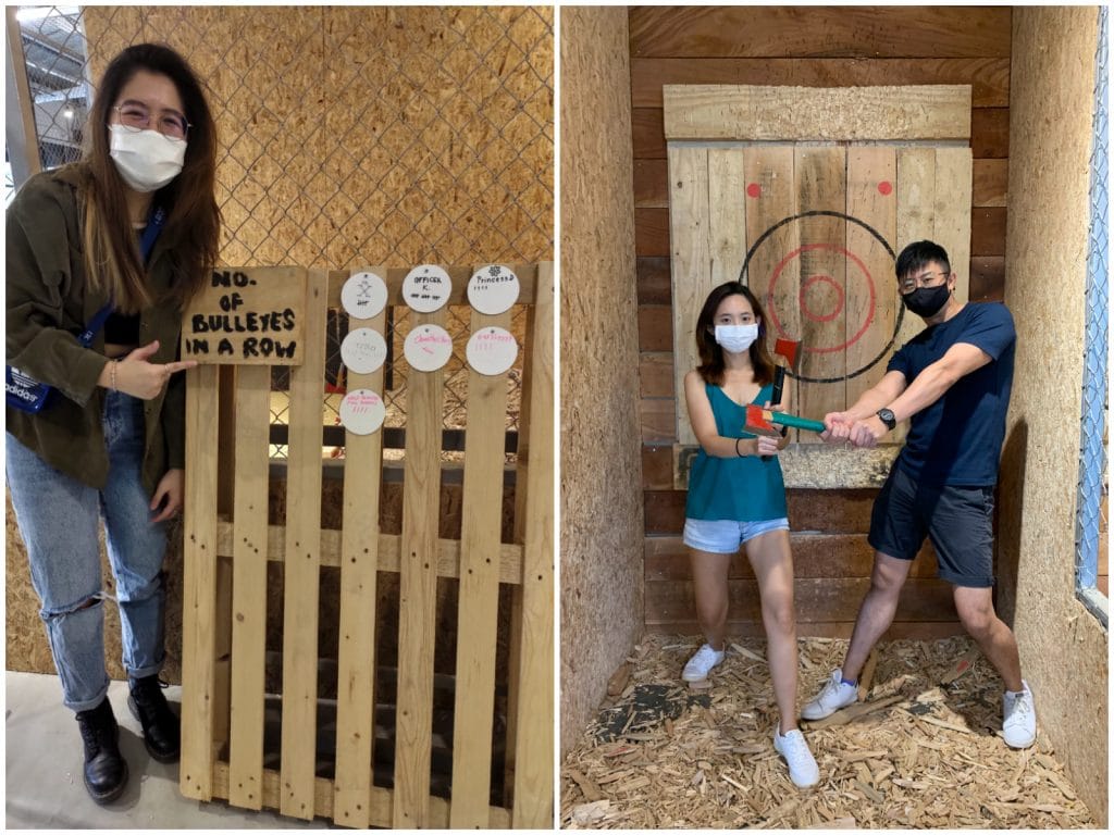 people posing in front of axe throwing target
