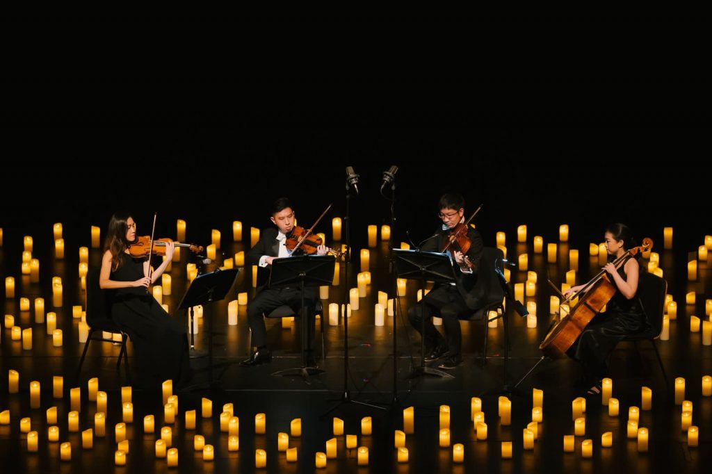 string quartet surrounded by candles for candlelight concert