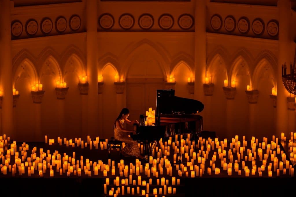 A pianist plays amongst hundreds of flameless candles at a Candlelight Concerts event in Singapore