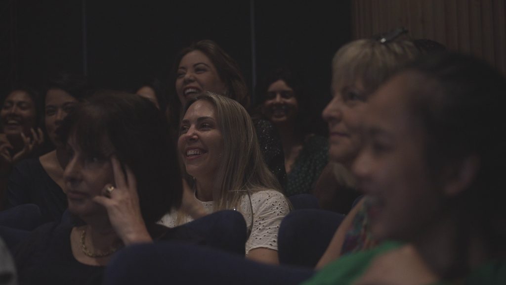 audience members clapping, laughing, smiling at magic show in singapore