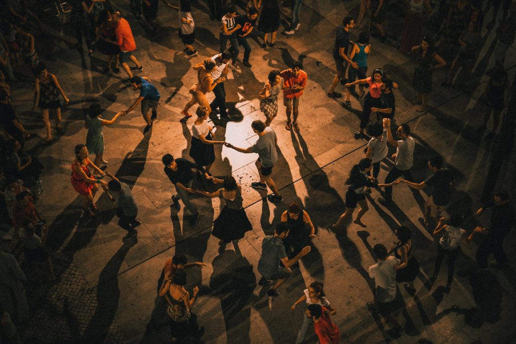 people dancing salsa, bachata, kizomba on a dancefloor