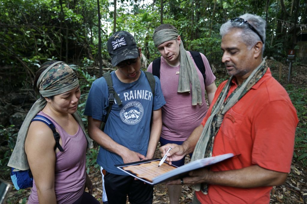 group of four people completing missions on tour of fort serapong in Singapore by beyond expeditions