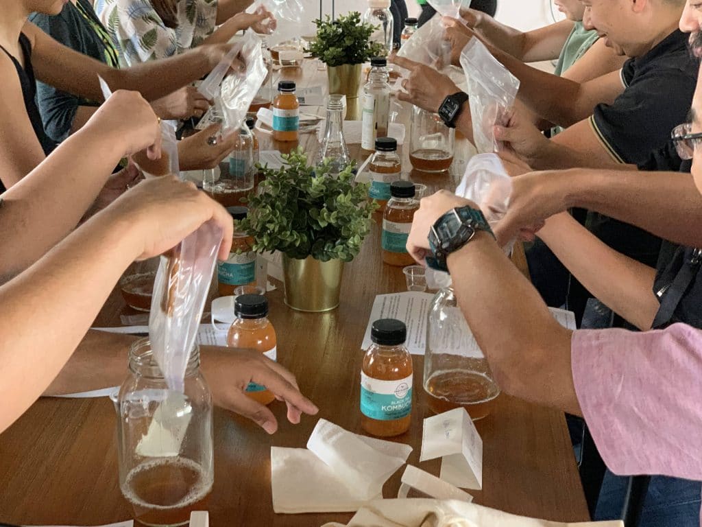 people making kombucha at a workshop